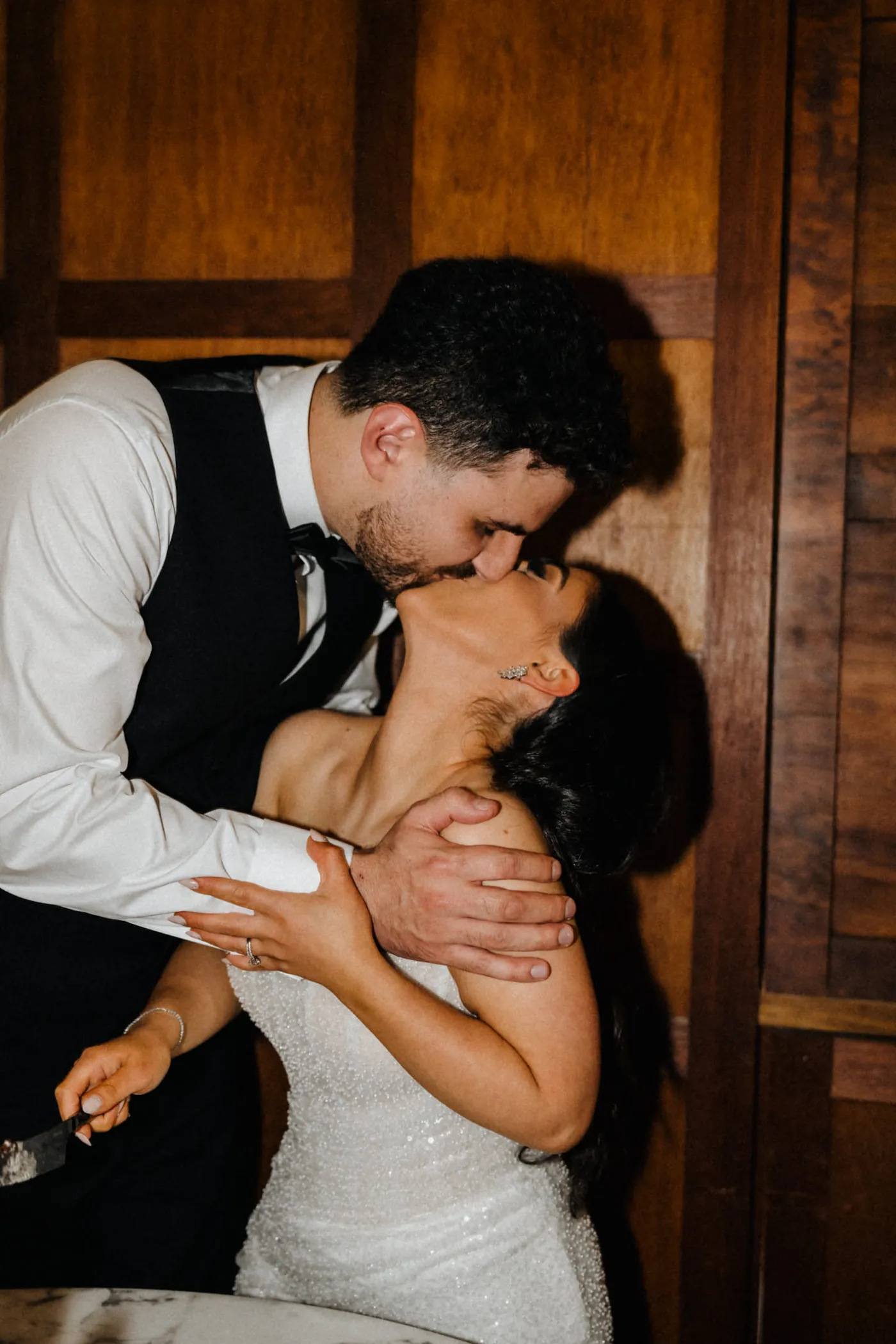 Couple sharing a kiss in a wood panelled room