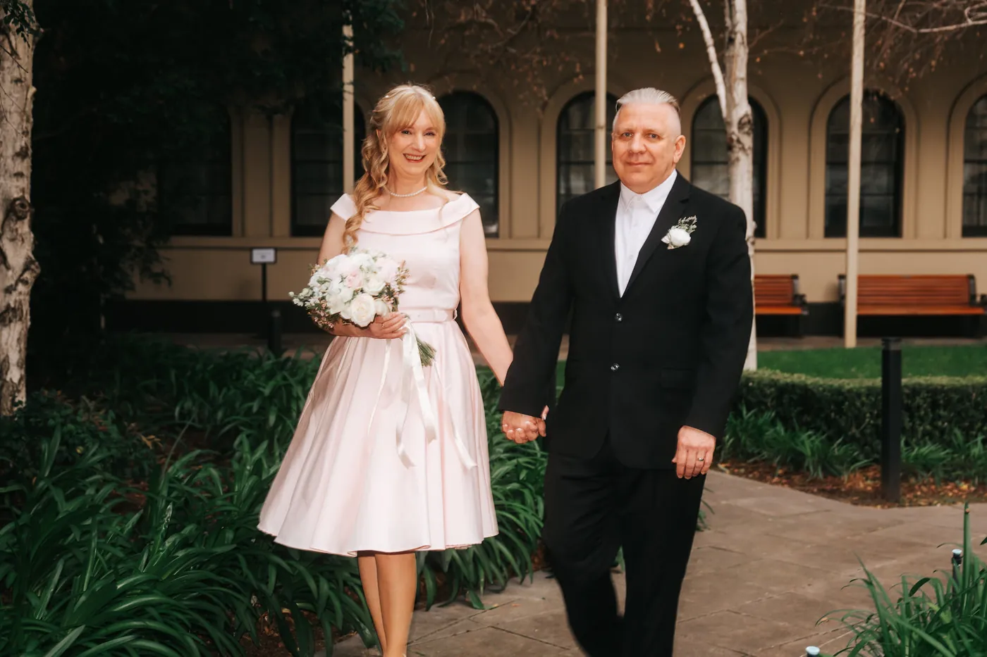 Couple walking through a city garden