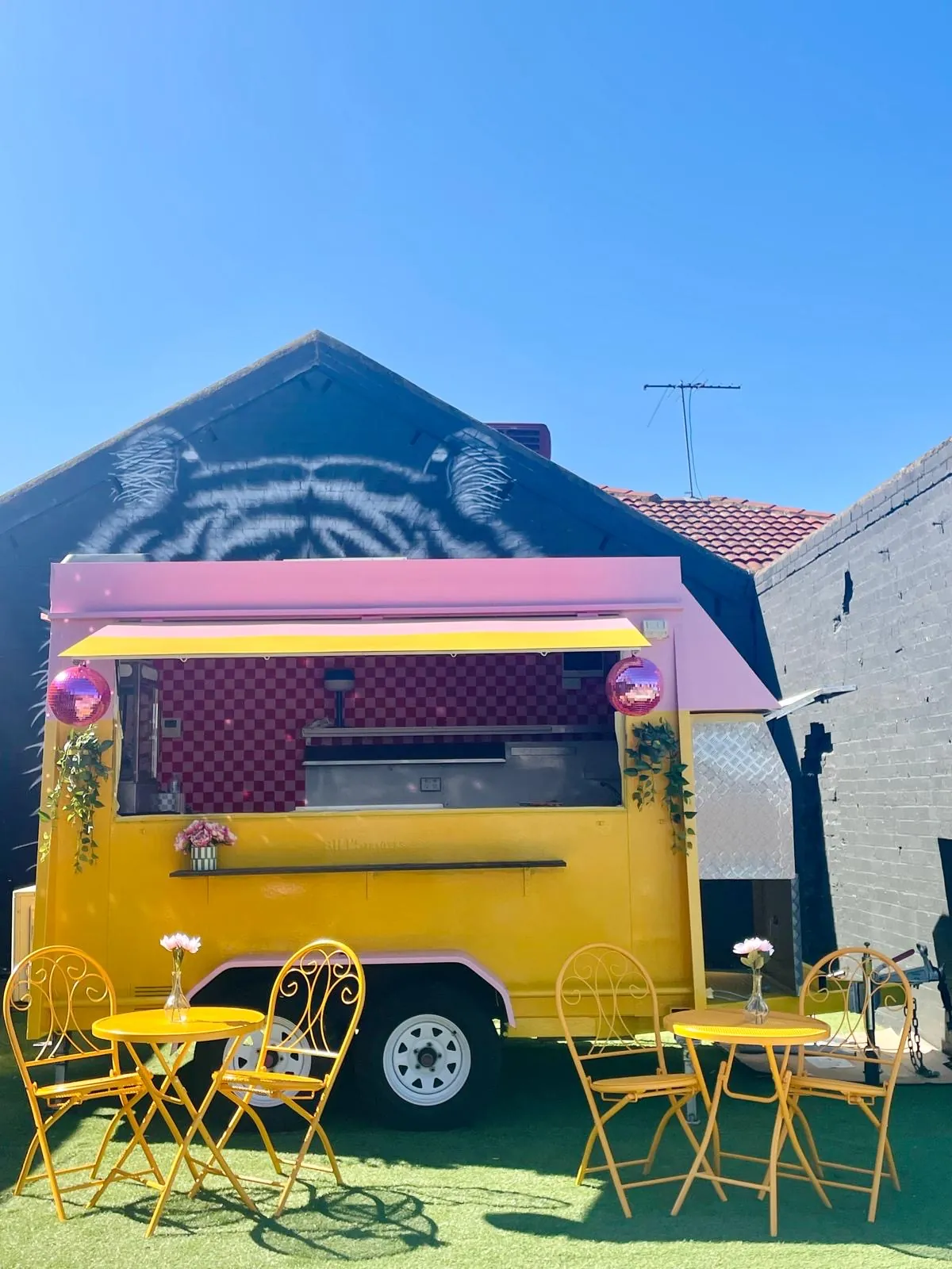 Pink and yellow La La Latte coffee trailer with garden seating